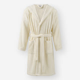 Cream hooded bathrobe with front pockets and a tie belt, displayed against a light neutral background.