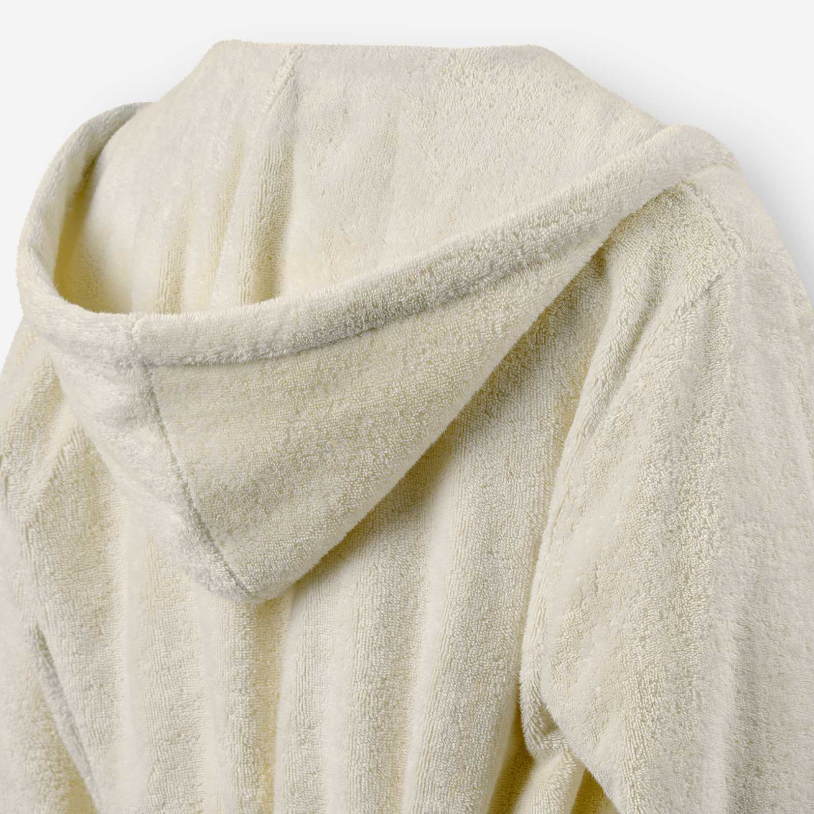 Close-up of the back of a cream terry cotton bathrobe showing the hood detail.
