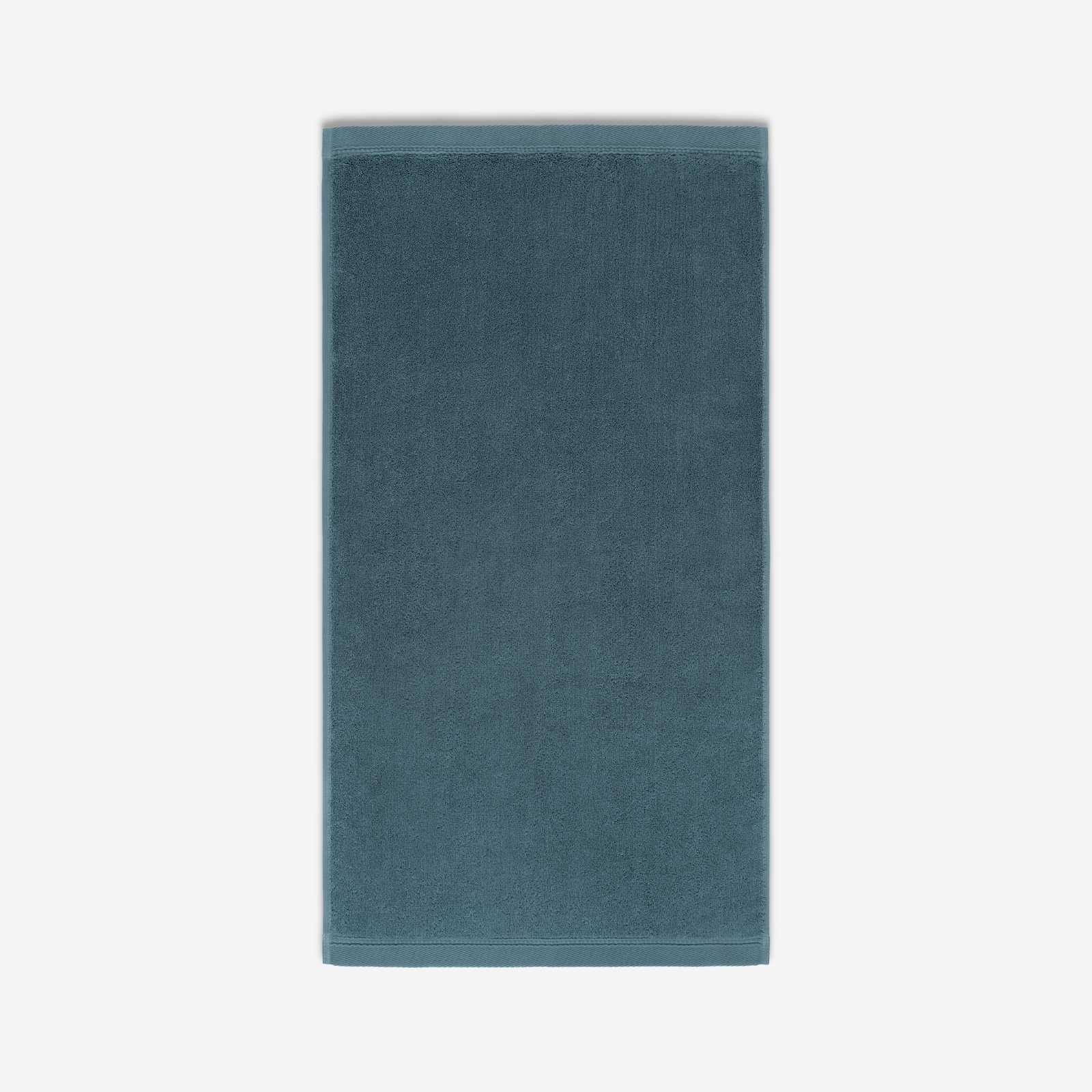 Teal cotton bath sheet in vertical orientation with woven border bands, shown against a white background.