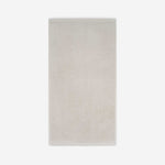 Light beige cotton bath sheet in vertical orientation with woven border bands, shown against a white background.