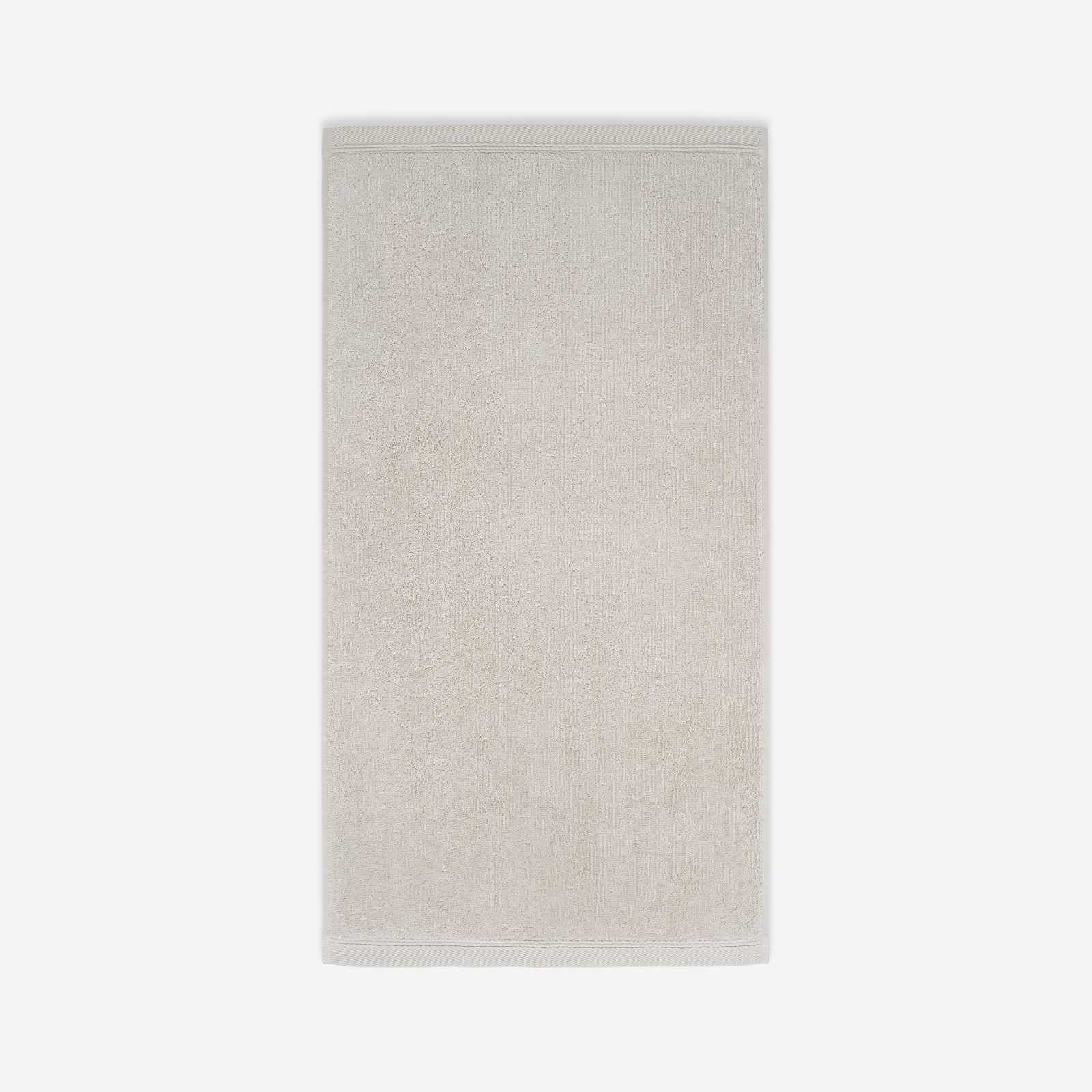 Light beige cotton bath sheet in vertical orientation with woven border bands, shown against a white background.
