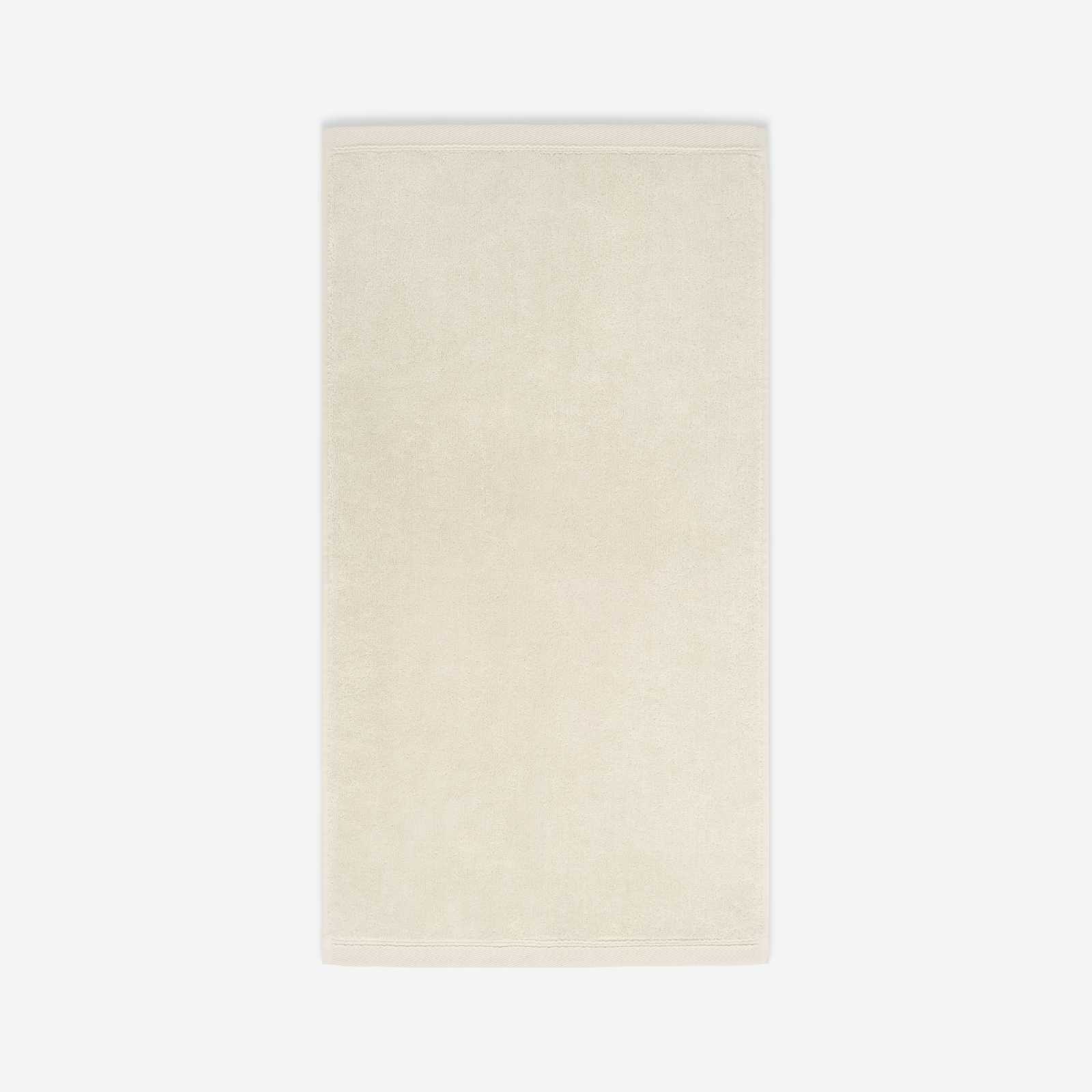 Cream cotton bath sheet in vertical orientation with woven border bands, shown against a white background.