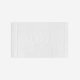 White bath mat with a tonal embroidered logo, shown in horizontal orientation against a white background.