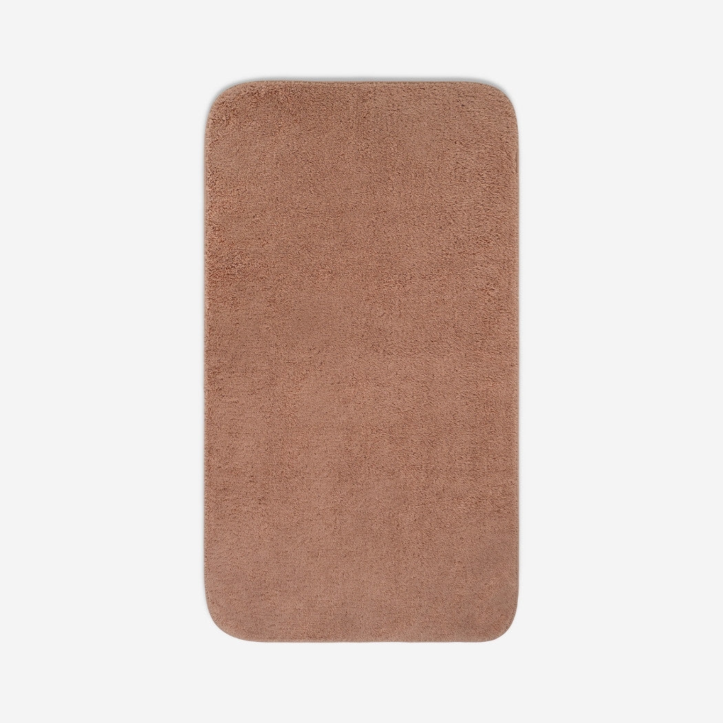 Top view of a dusty rose organic cotton bath sheet with rounded corners, displayed flat on a white background.
