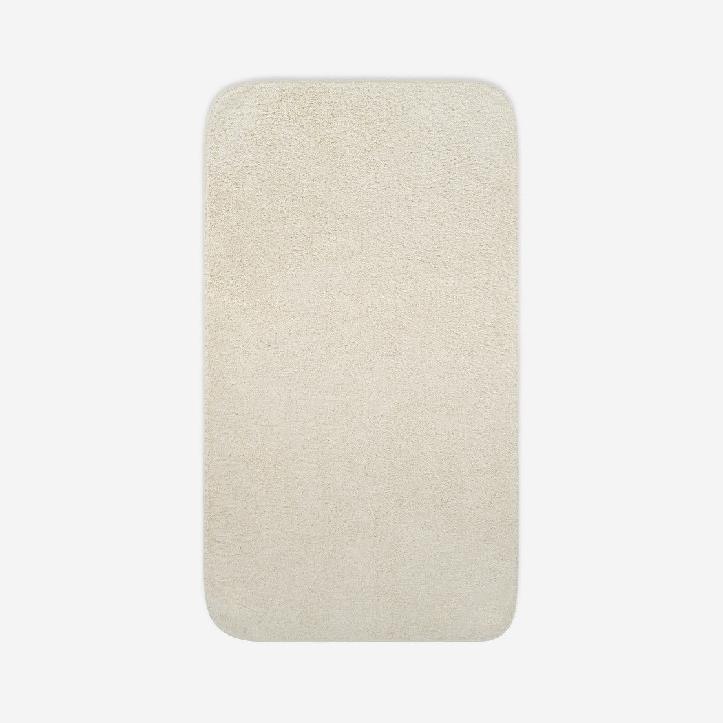 Top view of a light cream organic cotton bath sheet with rounded corners, displayed flat on a white background.