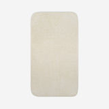 Top view of a light cream organic cotton bath sheet with rounded corners, displayed flat on a white background.