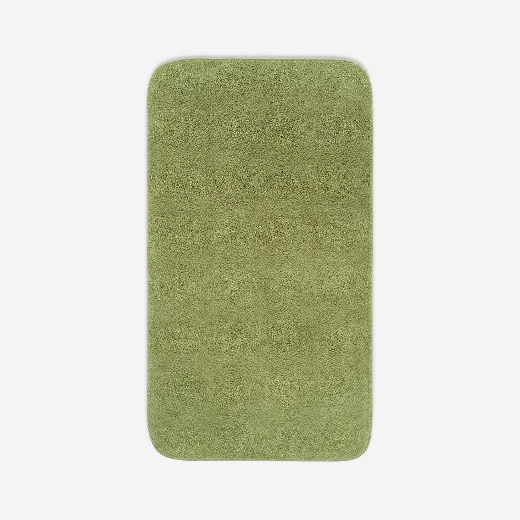 Top view of an olive green towel with rounded corners and visible terry texture, displayed on a light background, with a small embroidered logo in the lower corner.