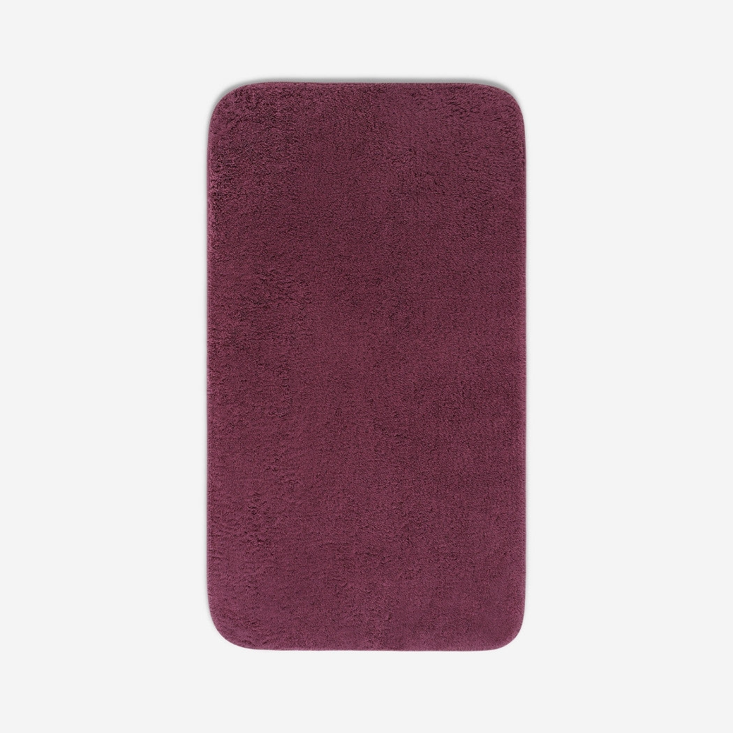 Top view of a purple organic cotton bath sheet with rounded corners, displayed flat on a white background.