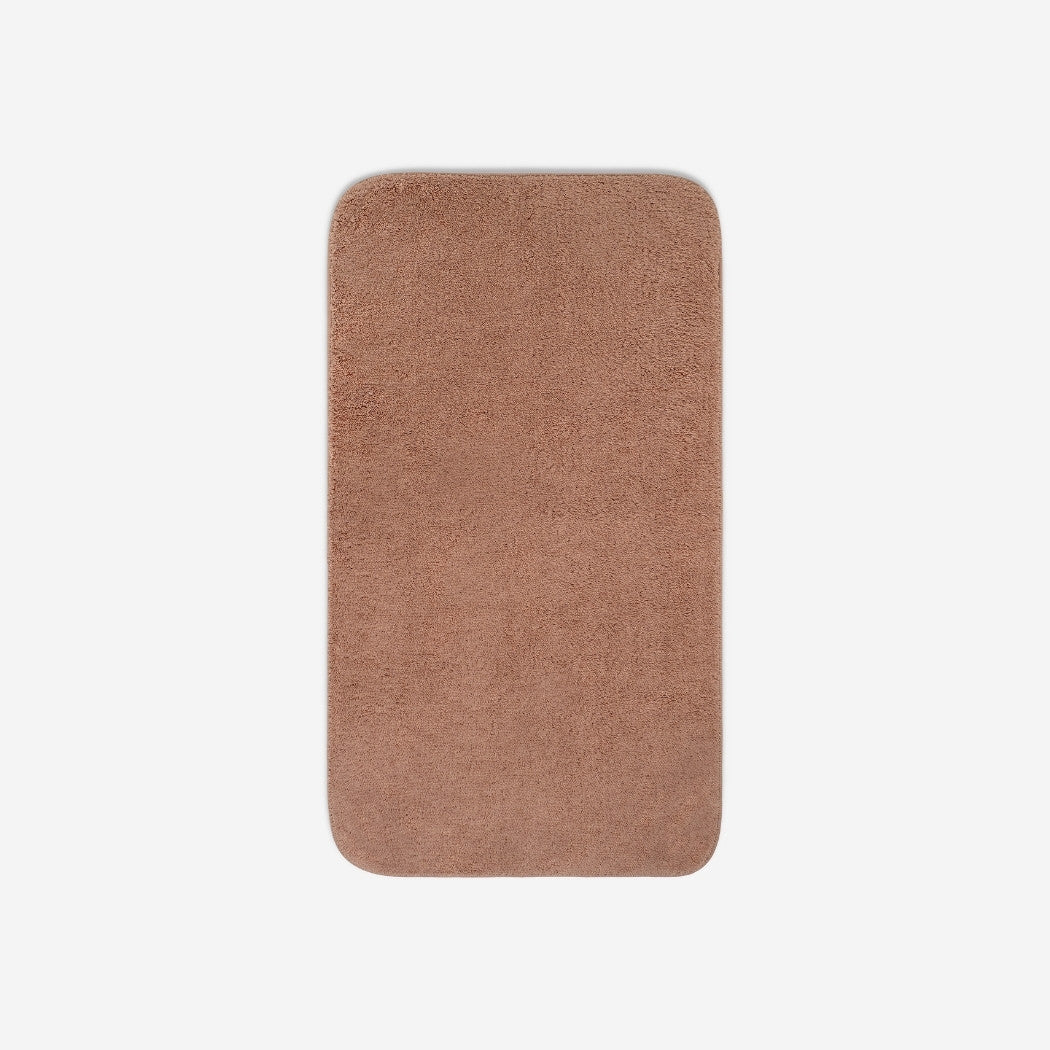 Top view of a dusty rose cotton bath towel with rounded corners, displayed flat on a white background.