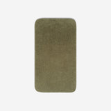 Top view of a dark olive organic cotton towel laid flat with rounded corners, shown on a white background.