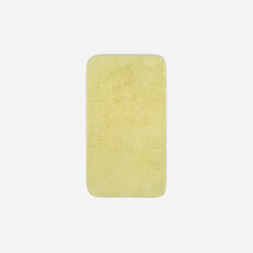 Top view of a yellow cotton face towel laid flat with rounded corners, shown on a white background.