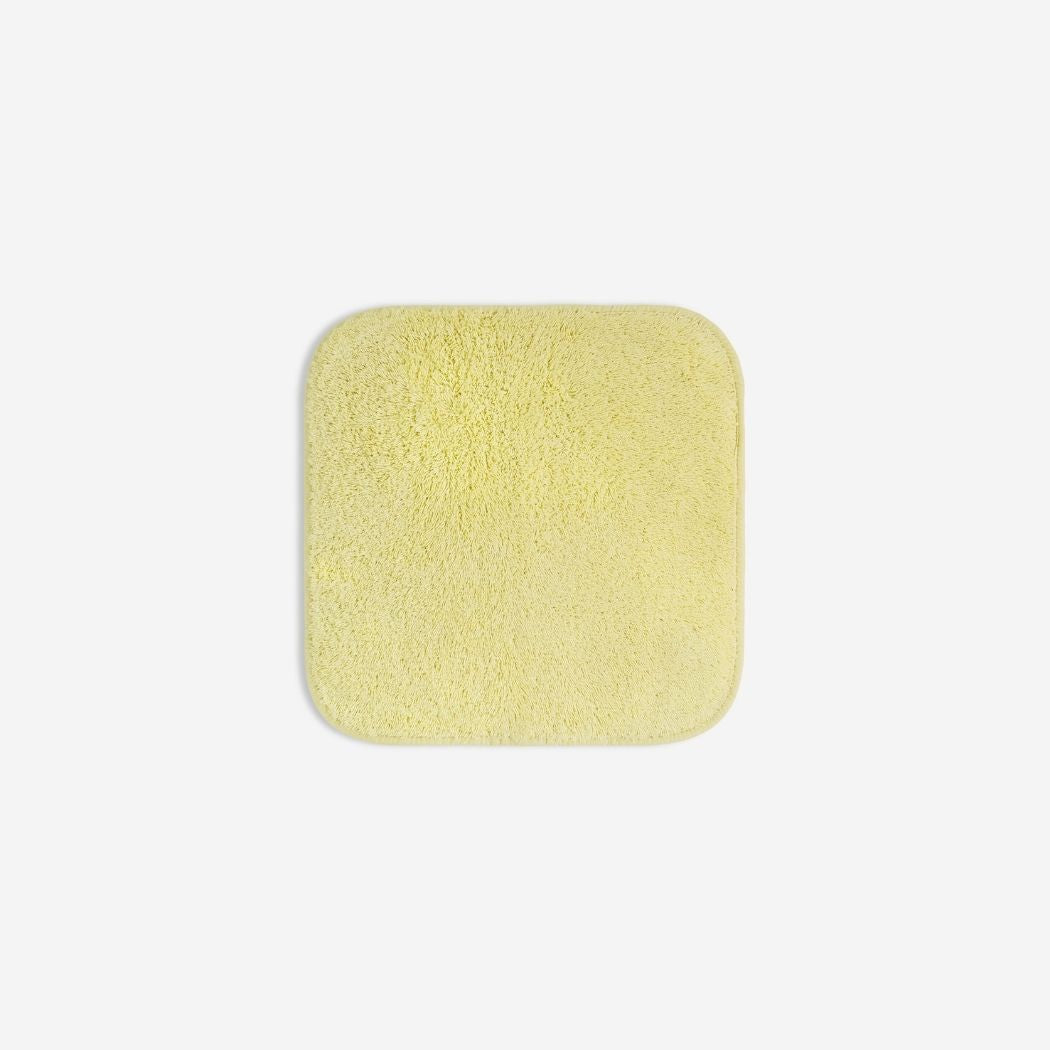 Yellow organic cotton washcloth.