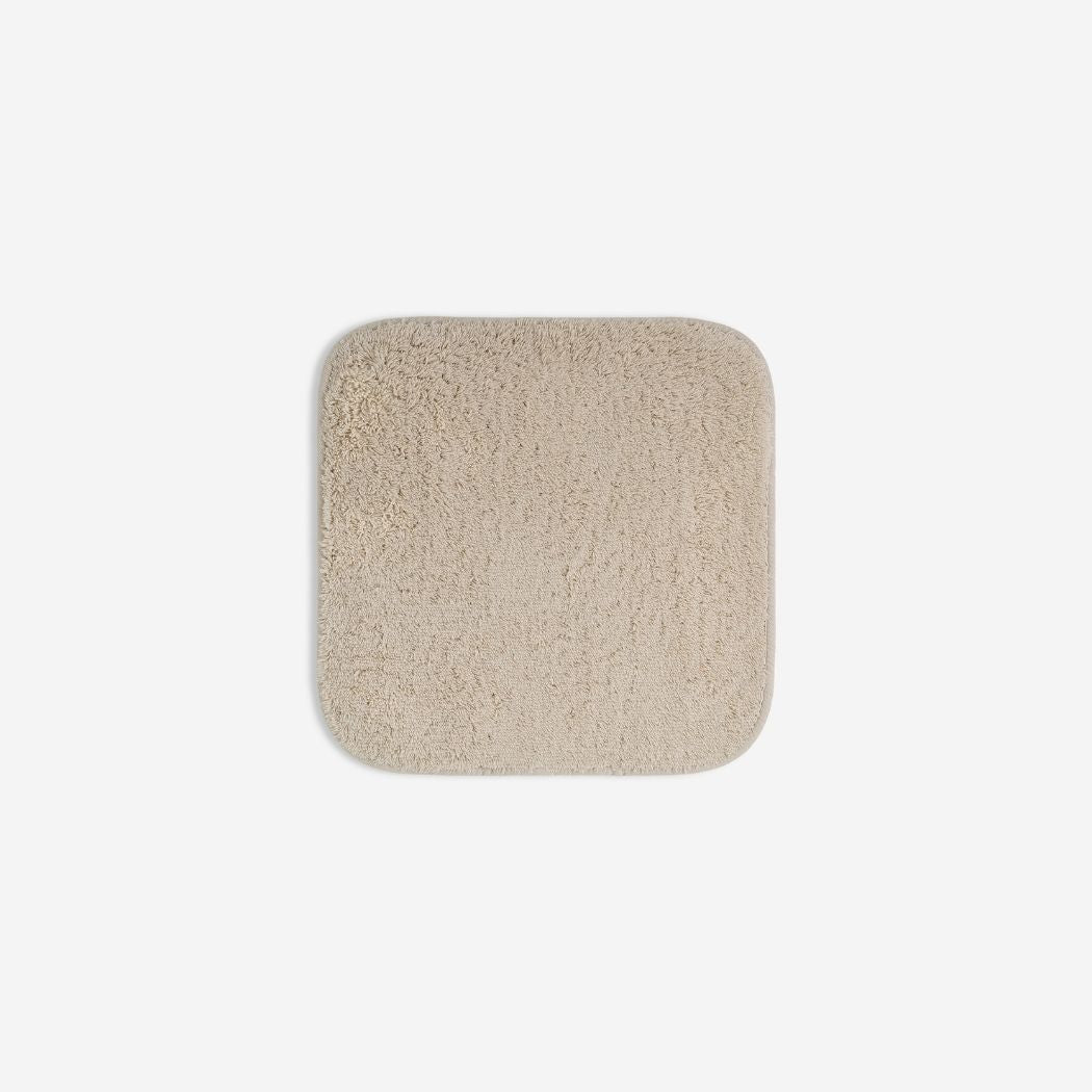 Beige organic cotton washcloth.