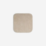 Beige organic cotton washcloth.