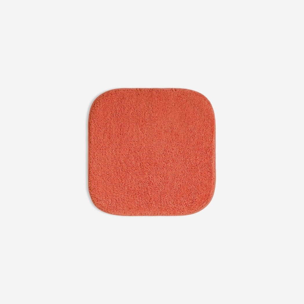 Orange organic cotton washcloth.