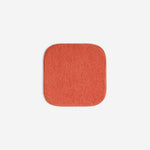 Orange organic cotton washcloth.