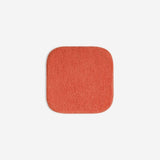 Orange organic cotton washcloth.