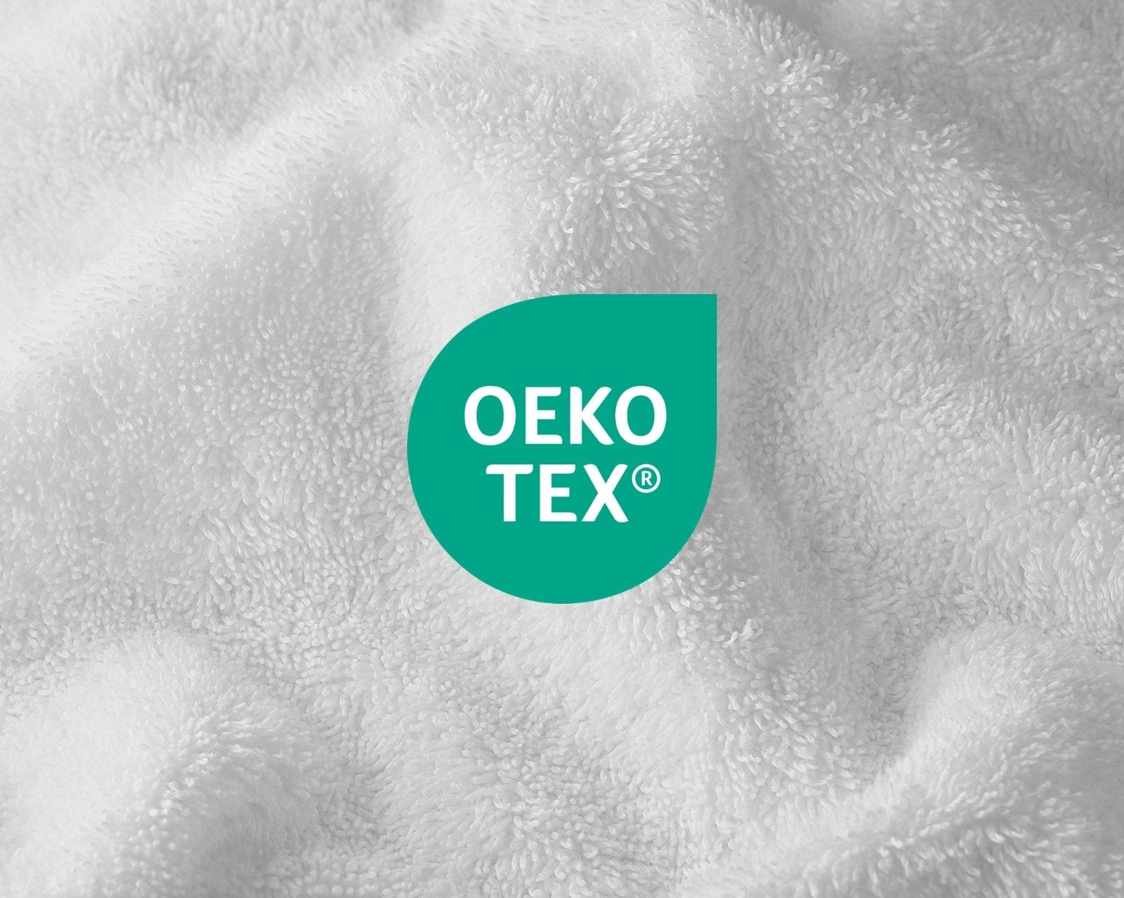 Close-up of OEKO-TEX logo on a textured white fabric background