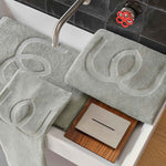 Gray bath mats with textured design on a bathtub