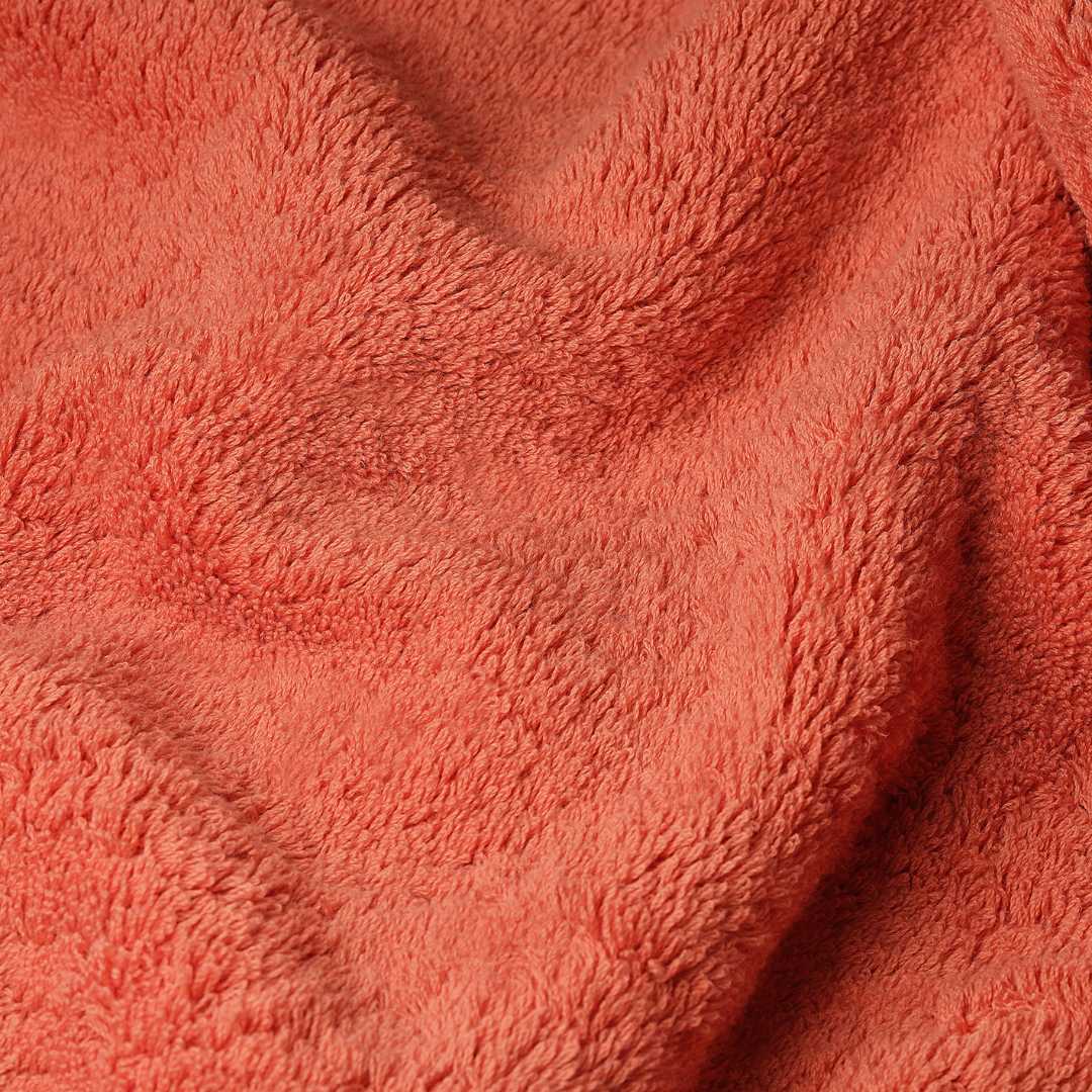 Close-up of a textured orange fabric.