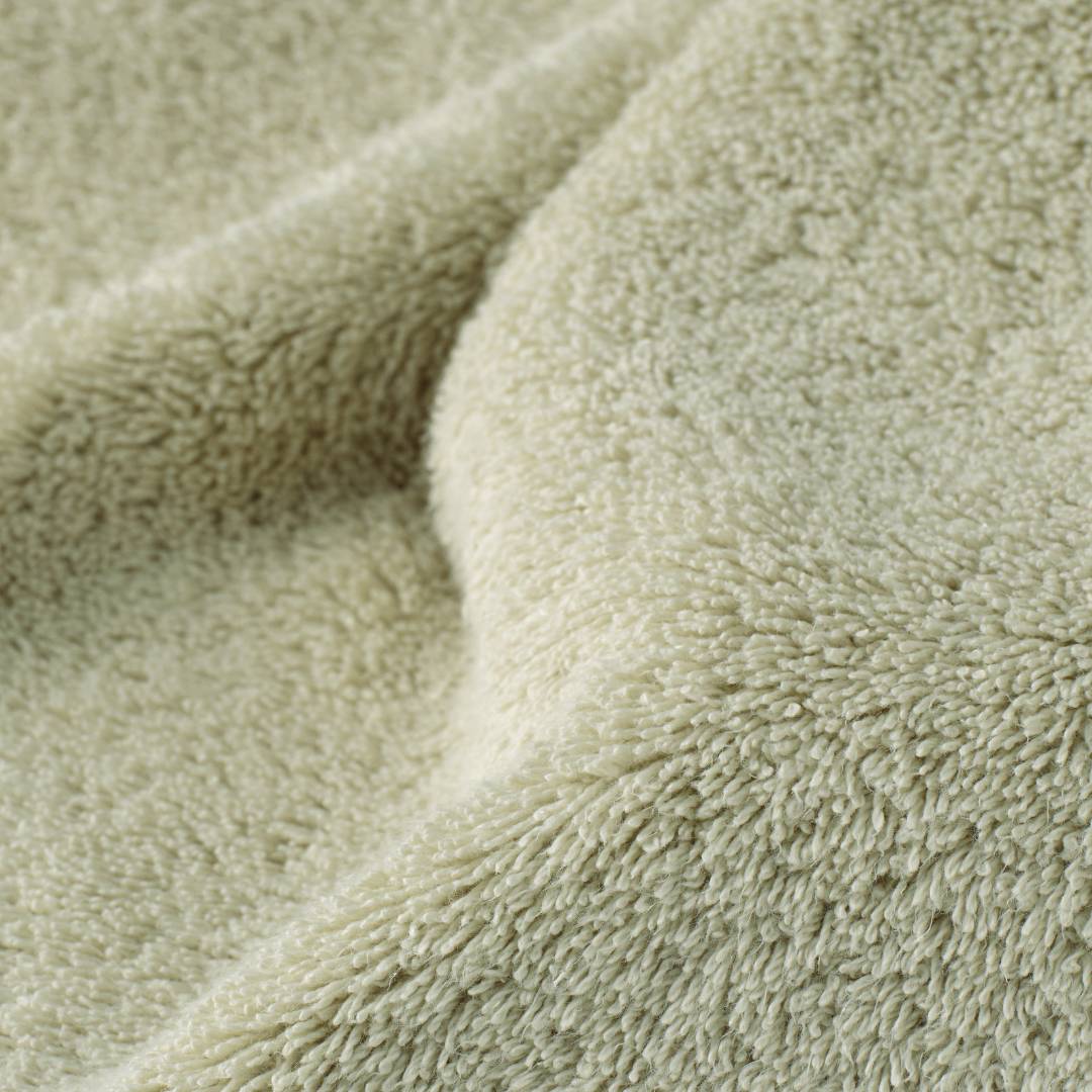 Close-up of a textured green fabric surface.