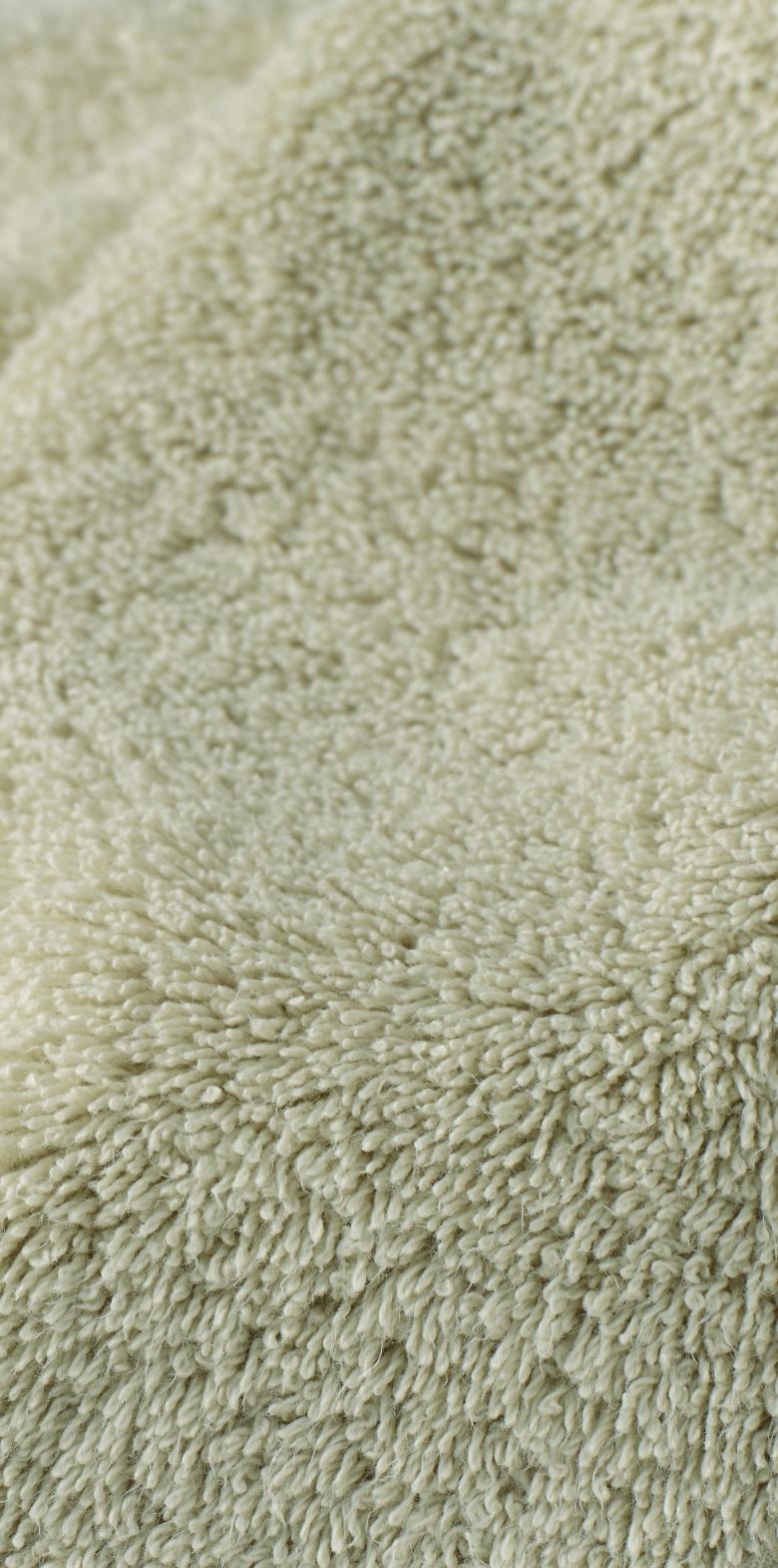 Close-up of a textured green fabric surface.